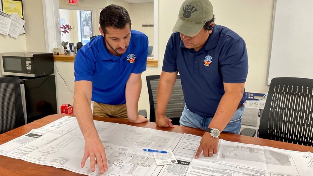 Phil DePaul reviews restoration plans with a colleague.